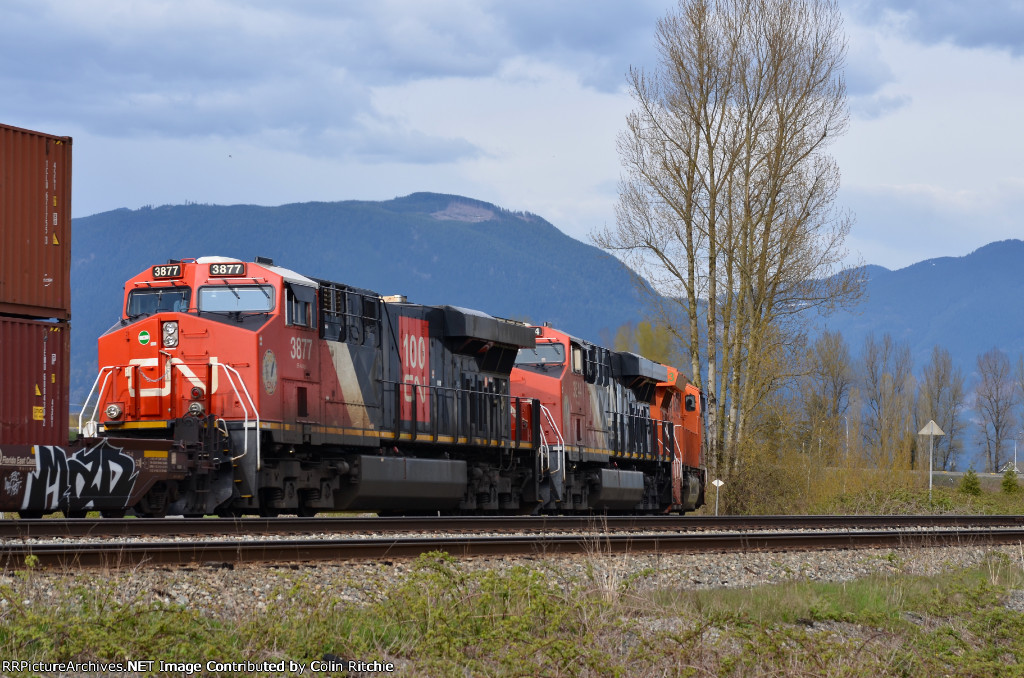 The "J", CN 3023, leading CN 3844 and 3877 and a unit stack train E/B towards the Mission swing bridge.